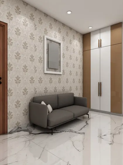 This image shows a simple yet elegant entryway or hallway with a comfortable sofa, patterned wallpaper, and a dual-toned wardrobe, demonstrating our solutions for transitional spaces.