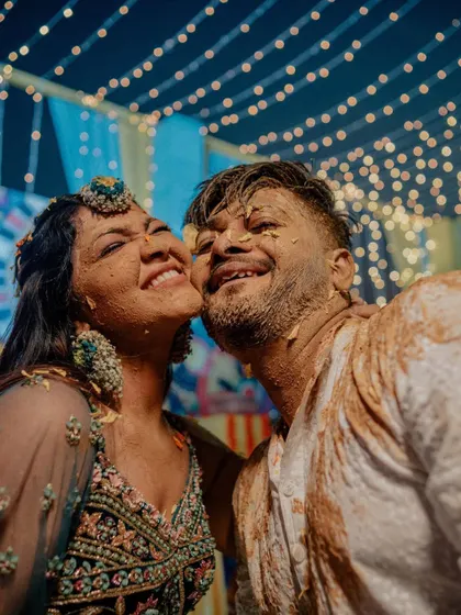The aftermath of a fun Haldi. This close-up of Saloni and Vatsal, covered in haldi and smiling from ear to ear, is a perfect picture of pure, messy happiness.