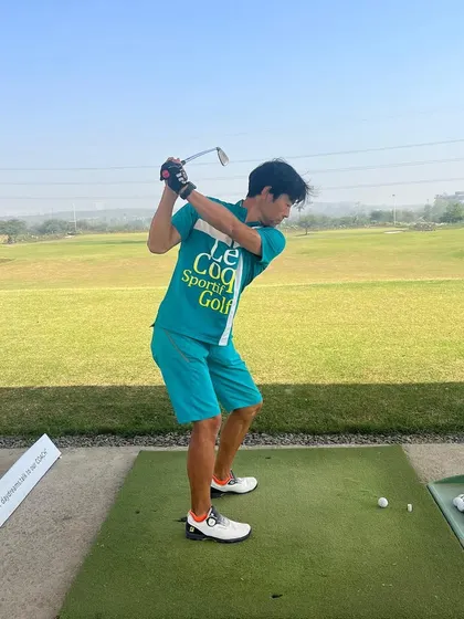 A junior golfer in bright attire enjoys his practice session. Our range is a vibrant and energetic place for all players.