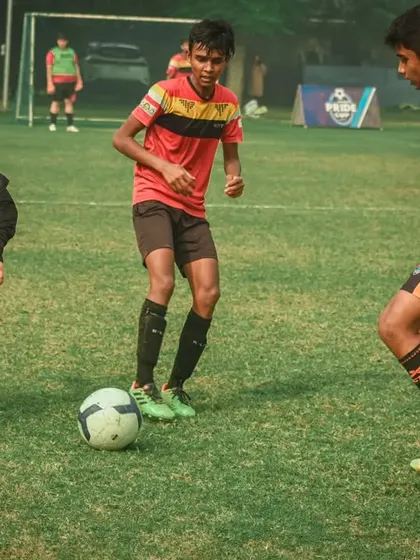 Intense focus as three players battle for possession.
