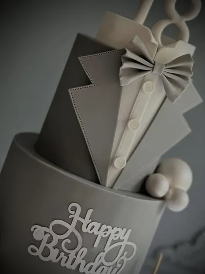 An angled shot highlighting the precise stitching detail on the fondant lapel. It's these small, perfect details that elevate a cake from homemade to professional.