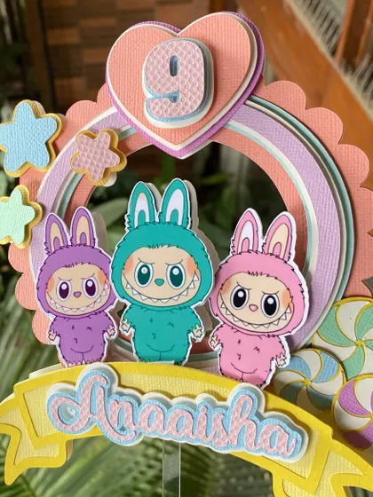 Another look at our layered Labubu cake topper. We love how the different shades of cardstock create depth and make the characters stand out.