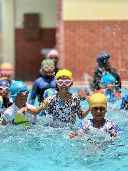 A snapshot of the energy and fun from one of our regular swimming classes. You can see our coaches right in the water with the kids, making a splash and learning together.