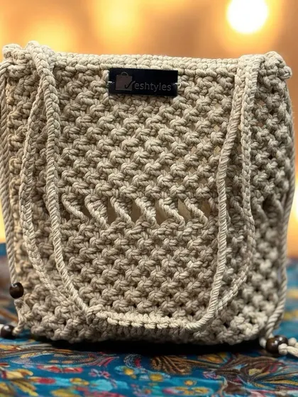 A simple beige potli-style bag, perfect for a minimalist festive look.