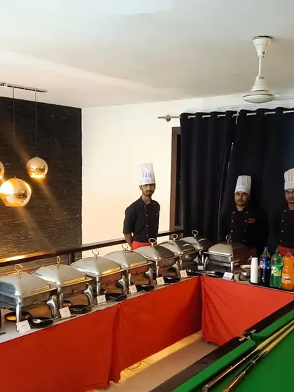 A unique catering setup in a recreational room with a pool table. We are experts at adapting our services to unconventional and stylish spaces.