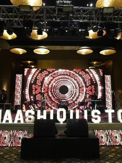 We bring your brand to the forefront with custom stage designs and branded elements. This stage for a corporate celebration features a dynamic LED backdrop with custom graphics and illuminated lettering of the event hashtag, creating a high-energy focal point.