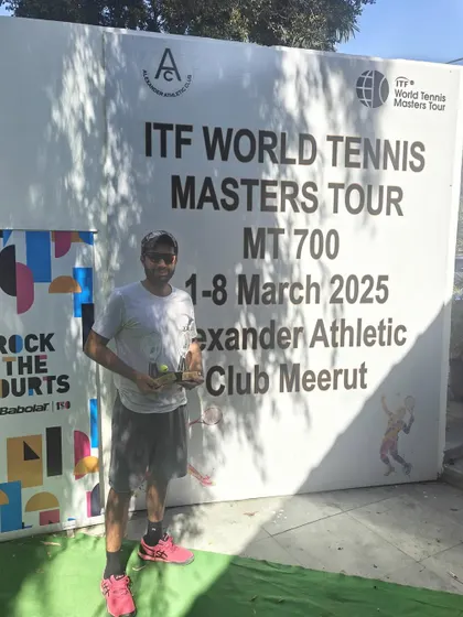 A solo shot with my trophy from the ITF MT700 event. This win was a result of dedicated training and a solid game plan.