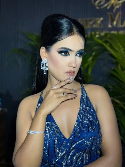 A close-up of the model's face, highlighting the intricate details of her eye makeup.