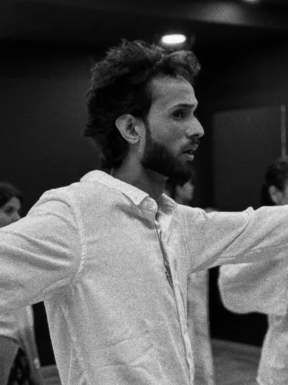 A black and white shot of our instructor demonstrating a move during the Contemporary workshop, capturing the focus and artistry involved.