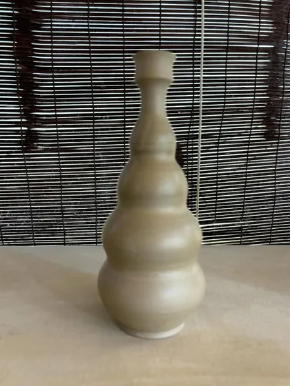 A collection of large, unglazed vases in various shapes and sizes. Each one is thrown on the wheel and showcases a different form, from classic curves to textured surfaces.