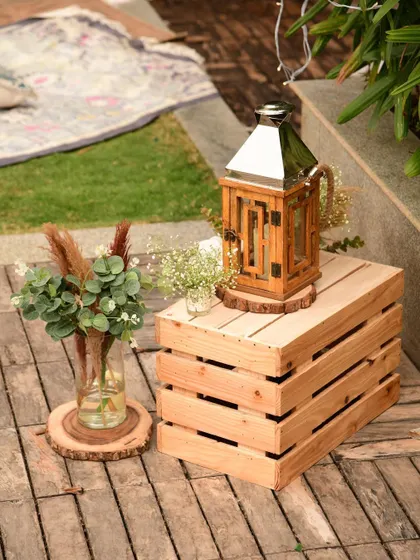 We used wooden crates and lanterns as accent pieces around the main seating area to enhance the natural, earthy, and rustic aesthetic.