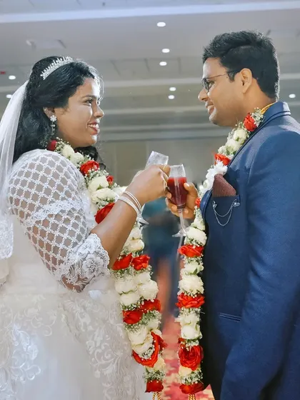 The wedding toast. A happy couple raises their glasses during their reception, a classic moment of celebration.