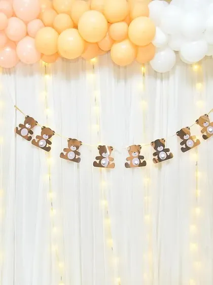 A close-up of the teddy bear backdrop, featuring a cute bunting and character cutouts.