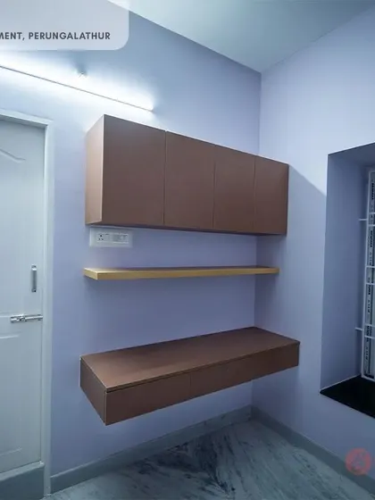 Another compact study unit from the Perungalathur project, with a floating desk and overhead storage in a calming lavender room.