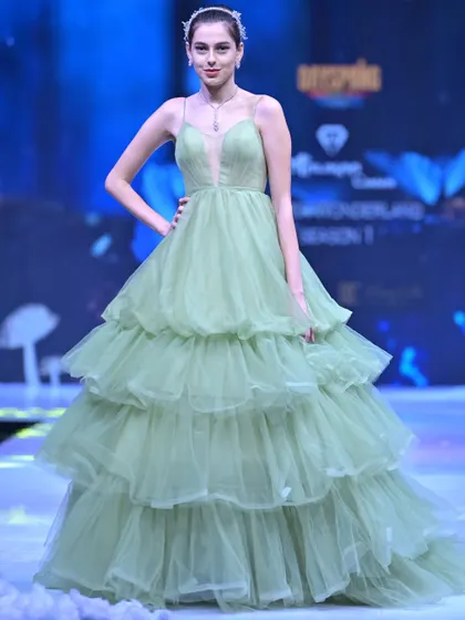 A fresh take on evening wear from my GULFAM collection. This sage green gown features a plunging neckline and a dramatic, multi-tiered tulle skirt that creates beautiful volume and movement.