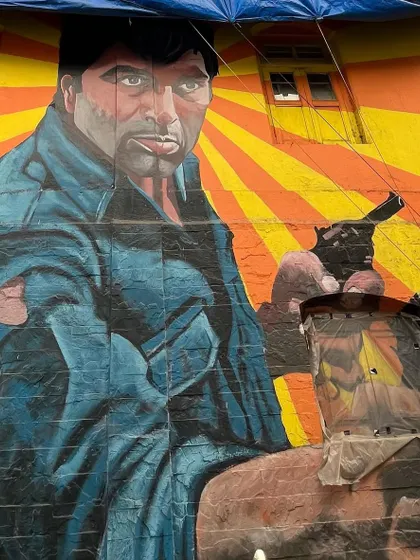 A vibrant mural of actor Amitabh Bachchan from the movie Deewaar, part of the Bollywood Art Project on Chapel Road, Bandra.