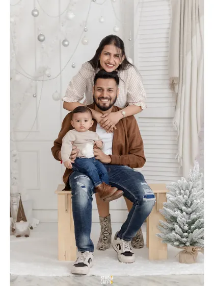 A happy family of three enjoying their first Christmas together in our white wonderland set.