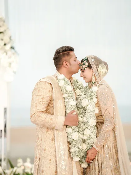 A tender forehead kiss. These intimate moments amidst the grandeur of the wedding are what make it so special.