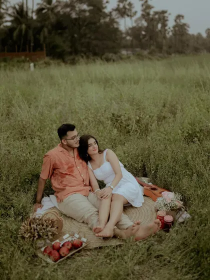 A peaceful shot of the couple relaxing together on their picnic blanket.