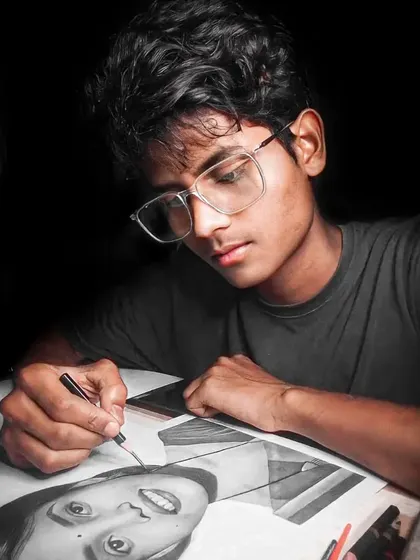 A photo of me at my workspace, focused on drawing a portrait. This gives a glimpse into the concentration and effort that goes into each piece.