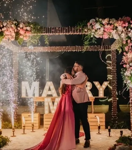 A celebratory hug surrounded by sparks of joy. The cold pyro effects add a touch of drama and excitement, making the proposal moment even more spectacular and photo-worthy.