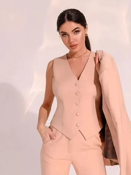 The boss babe is back. This image captures the confidence that comes with wearing a perfectly tailored waistcoat and blazer, shown here in a neutral beige.