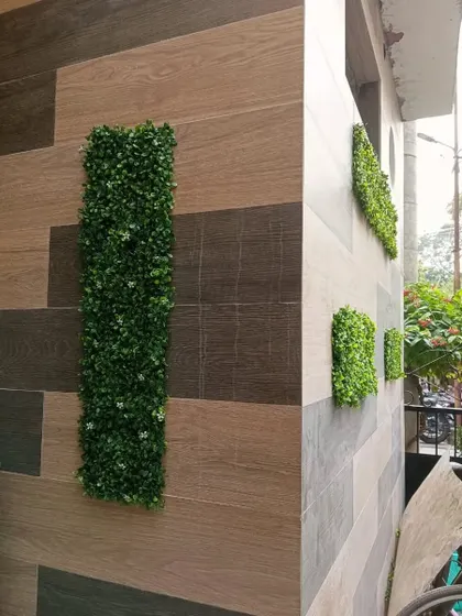 A view of the geometric green panels from the side, showing how they add dimension and visual interest to the corner of a building.