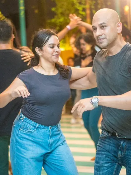 A close and connected dance, with both partners smiling.