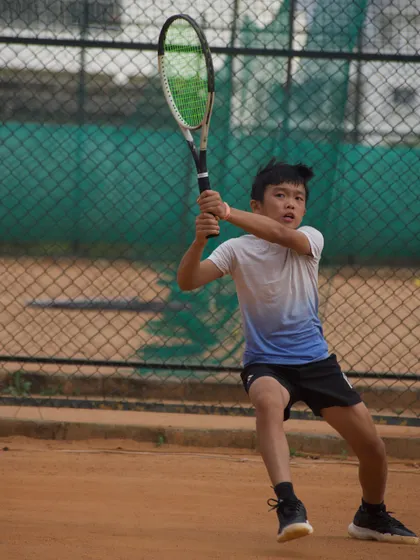 A player from our Tennex Sports Singapore camp demonstrates a powerful two-handed backhand. We focus on building strong technical foundations in all our athletes.