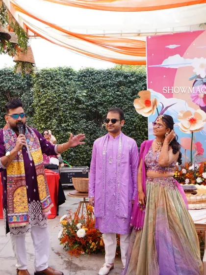 The couple on stage during their Haldi ceremony, with a quirky and colorful pop art backdrop adding a modern twist.