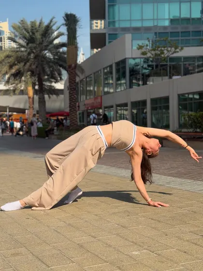 A backbend pose on the streets of Dubai. This demonstrates the level of flexibility and control that I teach, helping my clients achieve poses they never thought possible.