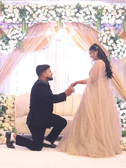 The proposal moment. This wide shot shows how the bride's entire look, from the flowing gown to the elegant hair, comes together to create a fairytale picture.