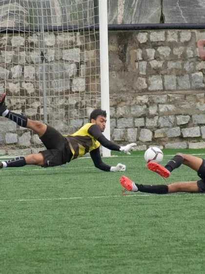 An action shot of Akash Kola making a diving save. His agility and reflexes are top-notch.