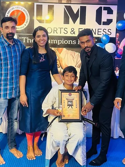 A proud family moment as a young student is awarded his black belt.