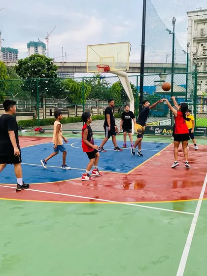Action under the hoop continues even after a downpour.