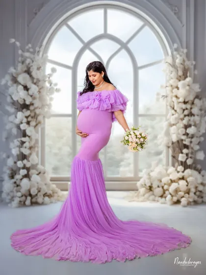 A duplicate of 110, this shot is all about making the mother-to-be feel like she's in a fairytale, with a stunning gown and a magical backdrop.