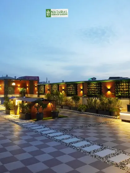 The Palam Vihar terrace at dusk, with the wall lights and planter lights creating a warm and inviting glow.