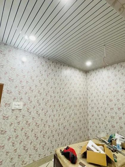This room is fully covered in a beautiful floral wallpaper, with a striped PVC panel ceiling. This shows how different patterns can work together to create a cohesive design.