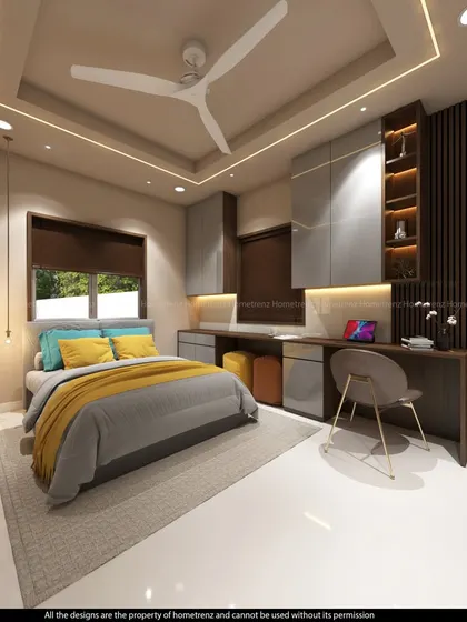 A kids' bedroom with a bright and cheerful color palette. The design includes a long study desk for two and plenty of storage in the form of overhead cabinets.