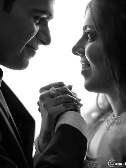 An intensely personal black and white close-up, where the bright background highlights the silhouette and connection of the couple.