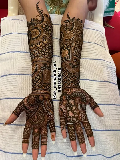 A complete bridal design with a mix of geometric and floral patterns, extending up to the elbows.