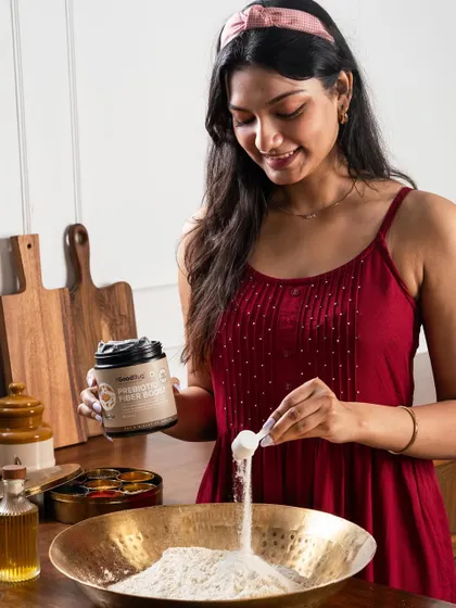 A shot showing a health supplement being mixed into atta (flour). This demonstrates the product's versatility and ease of integration into daily cooking.
