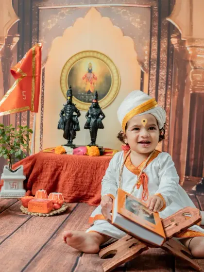 Another joyful expression, this time with the baby holding the book and looking directly at the camera.