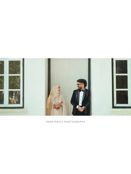 A wide shot showing the couple framed between two windows, creating a sense of symmetry and cinematic style.