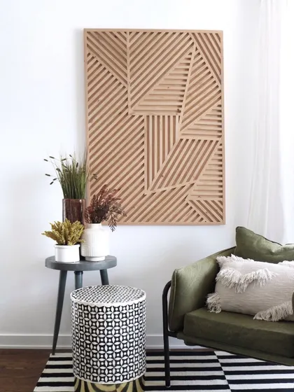 A vertical geometric wood panel shown in a stylish corner. Its elongated form is perfect for narrower walls or for creating a sense of height in a room.