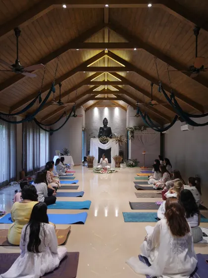 I guide an intimate group of women through a workshop on hormonal health and yoga. I believe in keeping groups small to foster personal connection and ensure everyone feels seen and supported in their wellness journey.