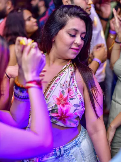 A stylish guest enjoying the party atmosphere.