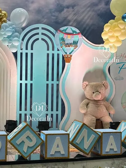 Another view of the grand stage, with custom "PRANAY" blocks and a beautiful sky-themed backdrop.