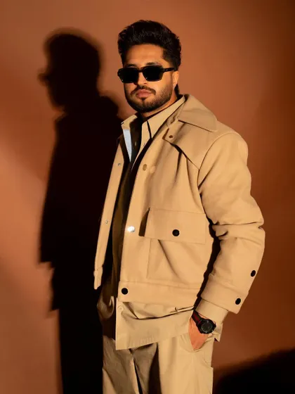 A three-quarter portrait where the lighting creates a strong shadow, adding depth to the image.