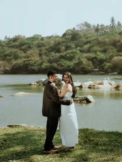 The couple shares a slow dance by the lake, a candid moment of romance and happiness during their nature-themed pre-wedding photoshoot.